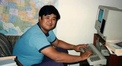 Ken Uchikura working on an old apple computer